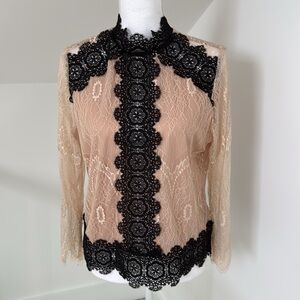 The Buckle lave and cream and black key hole button blouse.